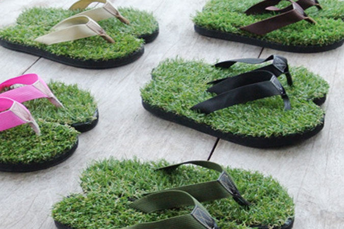 Groundwalk sandals in many colors on a wood table